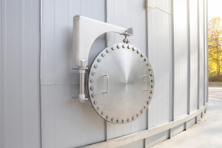 Inspection hatch mounted on the side of a hot water buffer tank at Royal Swinkels