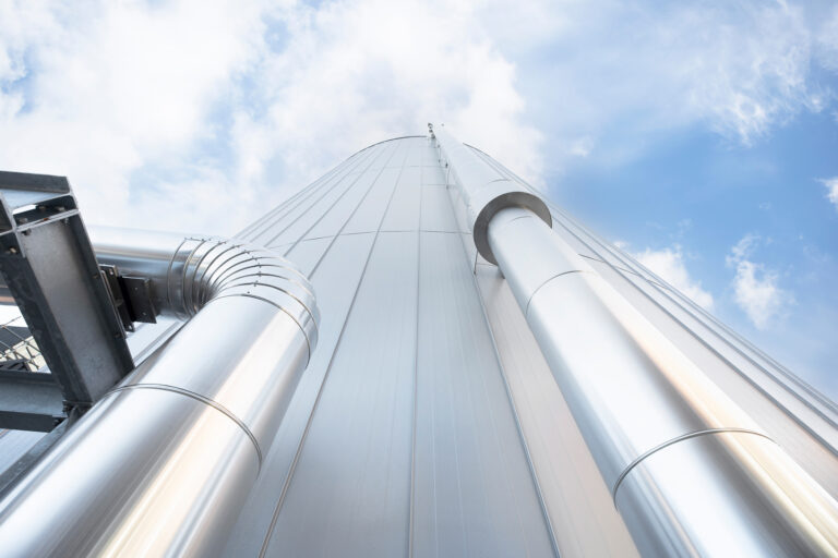 Insulated pipes running along the side of a hot water buffer tank at Royal Swinkels